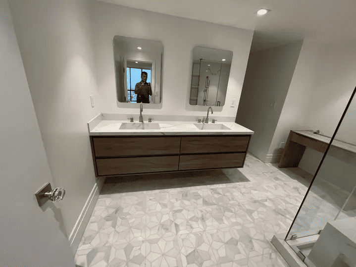 renovated bathroom with double vanity and mirrors