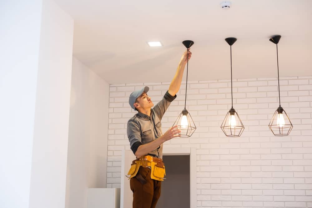 Electrician Worker Installation Electric Lamps Light Inside Apartment.