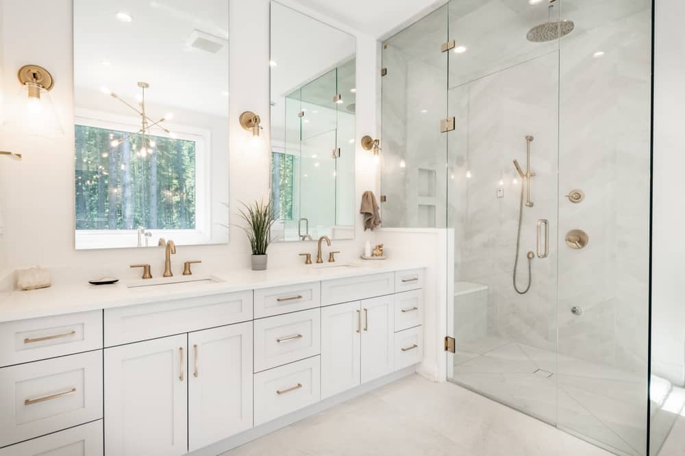 white modern bathroom with brass fixtures and hardware.